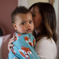 Load image into Gallery viewer, Mom carrying baby in Friendly Fox Zipadee-Zip swaddle transition