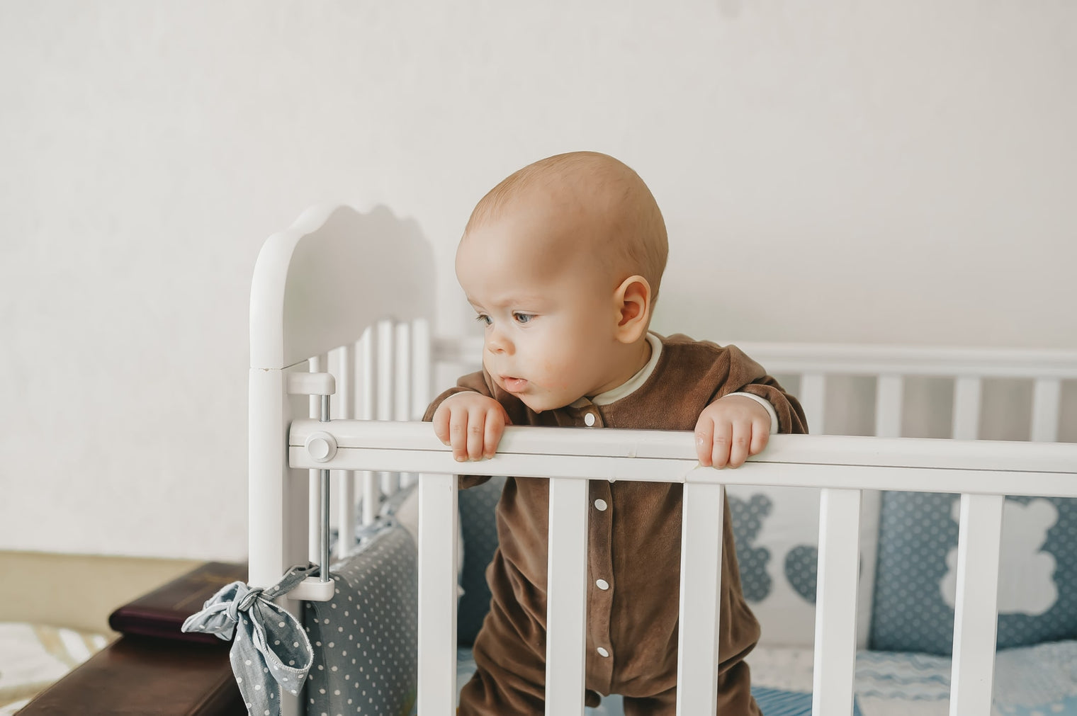 Sleep training baby in crib during daytime 