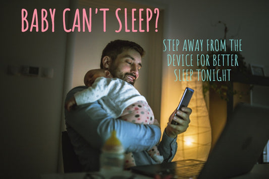 A father uses his phone while his baby can’t sleep