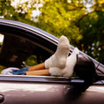 Load image into Gallery viewer, Person's feet in white socks sticking out of a car window with greenery in the background
