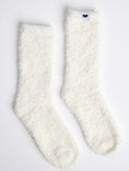 Load image into Gallery viewer, Pair of white fuzzy Little Giraffe socks on a light gray background
